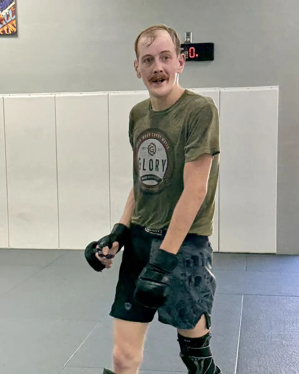 Brad Solomon, fitness kickboxing coach at Glory MMA & Fitness, on the mats in Glory gear