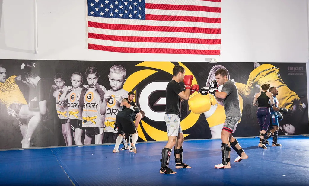 Members drilling pad work under the Glory mural