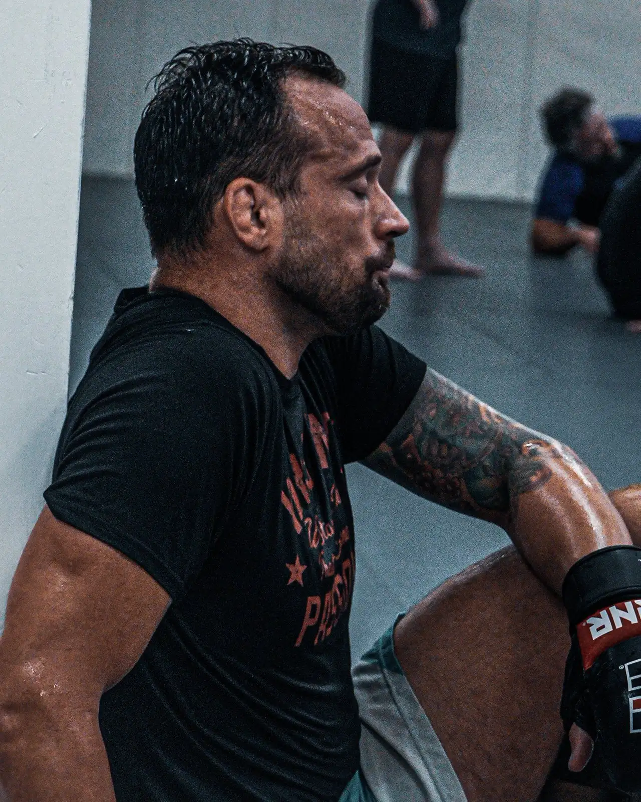 James Krause, owner and head coach of Glory MMA & Fitness, resting between rounds on the mats