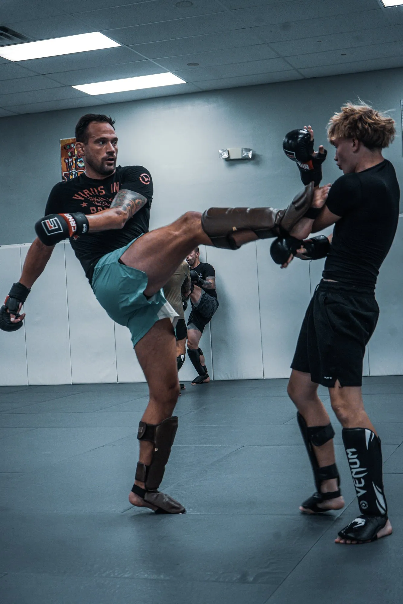 James Krause throwing a front kick as a student catches it