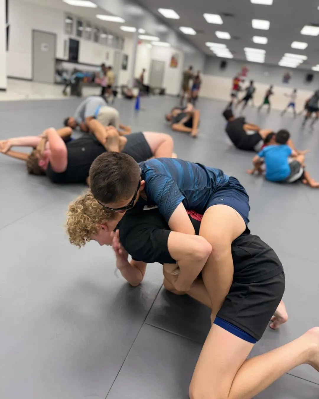 Youth no-gi grappling class on the mats